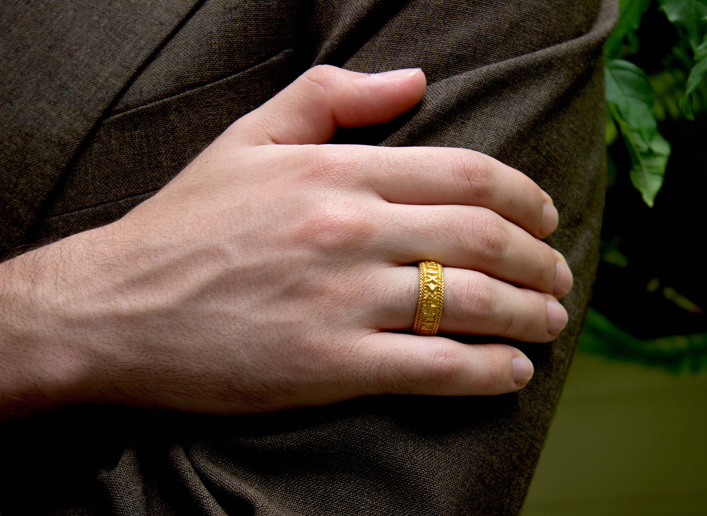 ring, ring on model, ring on hand, mens ring, womens ring, wedding band, mens wedding band, yellow gold ring. solid gold ring, runes ring, runes engraving, nordic runes ring, custom gold ring, personalized gold ring