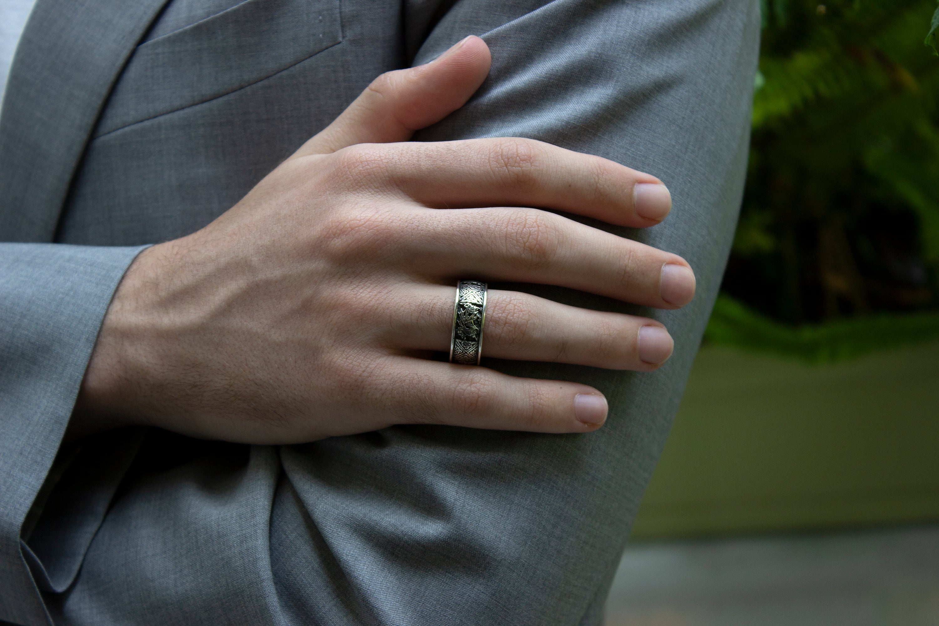 ring, ring on white background, sterling silver ring, oxidized ring, yellow gold plated ring, engraved ring, custom ring, custom engraving, celtic designs, celtic knot engraving, dragon engraving, dragon ring, unique ring, mens ring, women's ring, hand model, man wearing ring