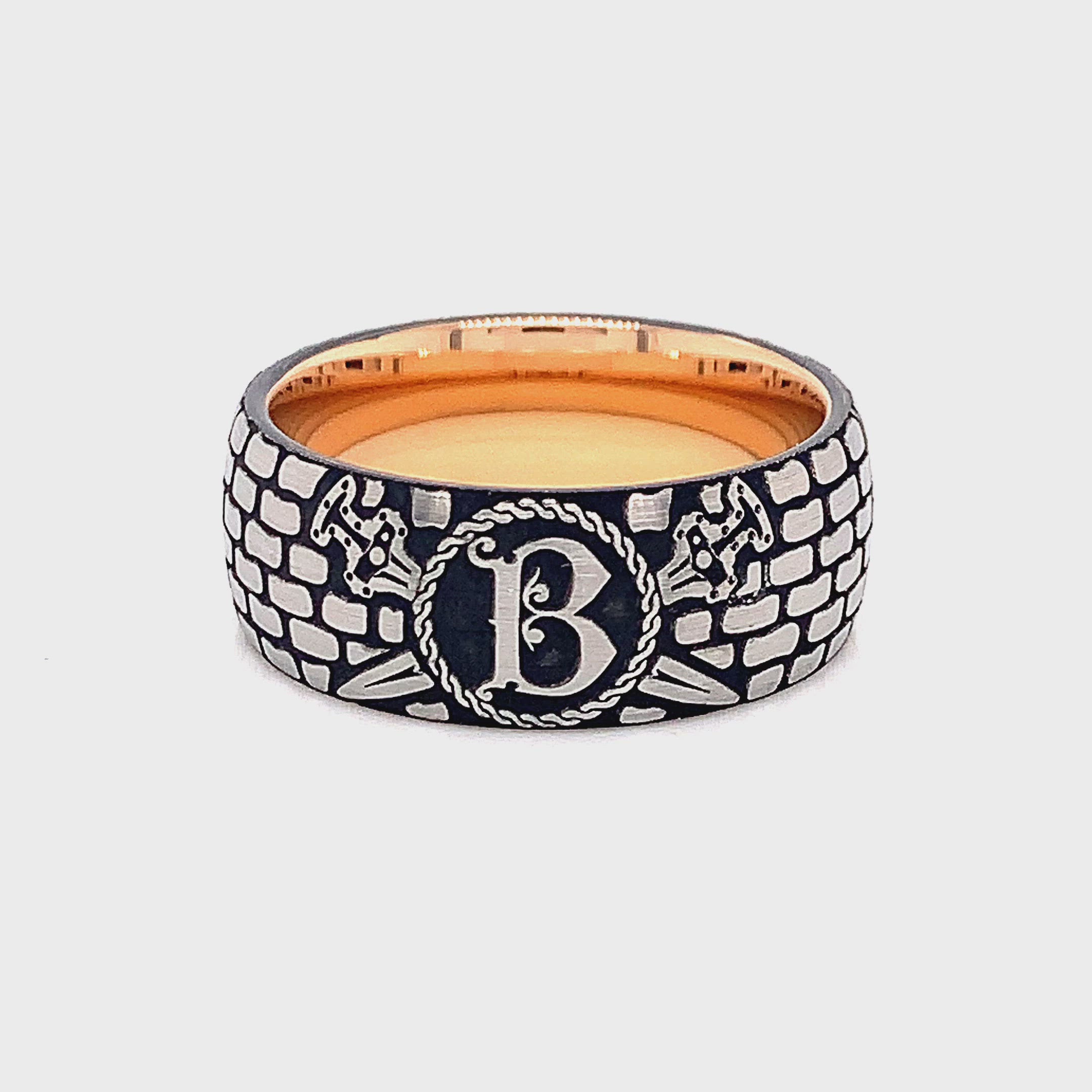 rin, ring on white background, ring with rose gold plating, ring with brick pattern, ring with initial, ring with letter g engraved, ring with ax engravings, viking inspired ring, viking ring, tungsten wedding band, mens wedding band, 9mm ring, women's wedding band, personalized wedding band, custom wedding band