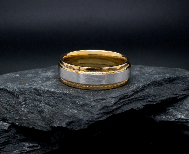 ring, ring on black background, mens rings, womens ring, unisex ring, two toned ring, yellow gold and white gold ring, brushed center, polished edges and interior, migrain engraving, stepped edges, wedding band, mens wedding band, womens wedding band, minimalist ring
